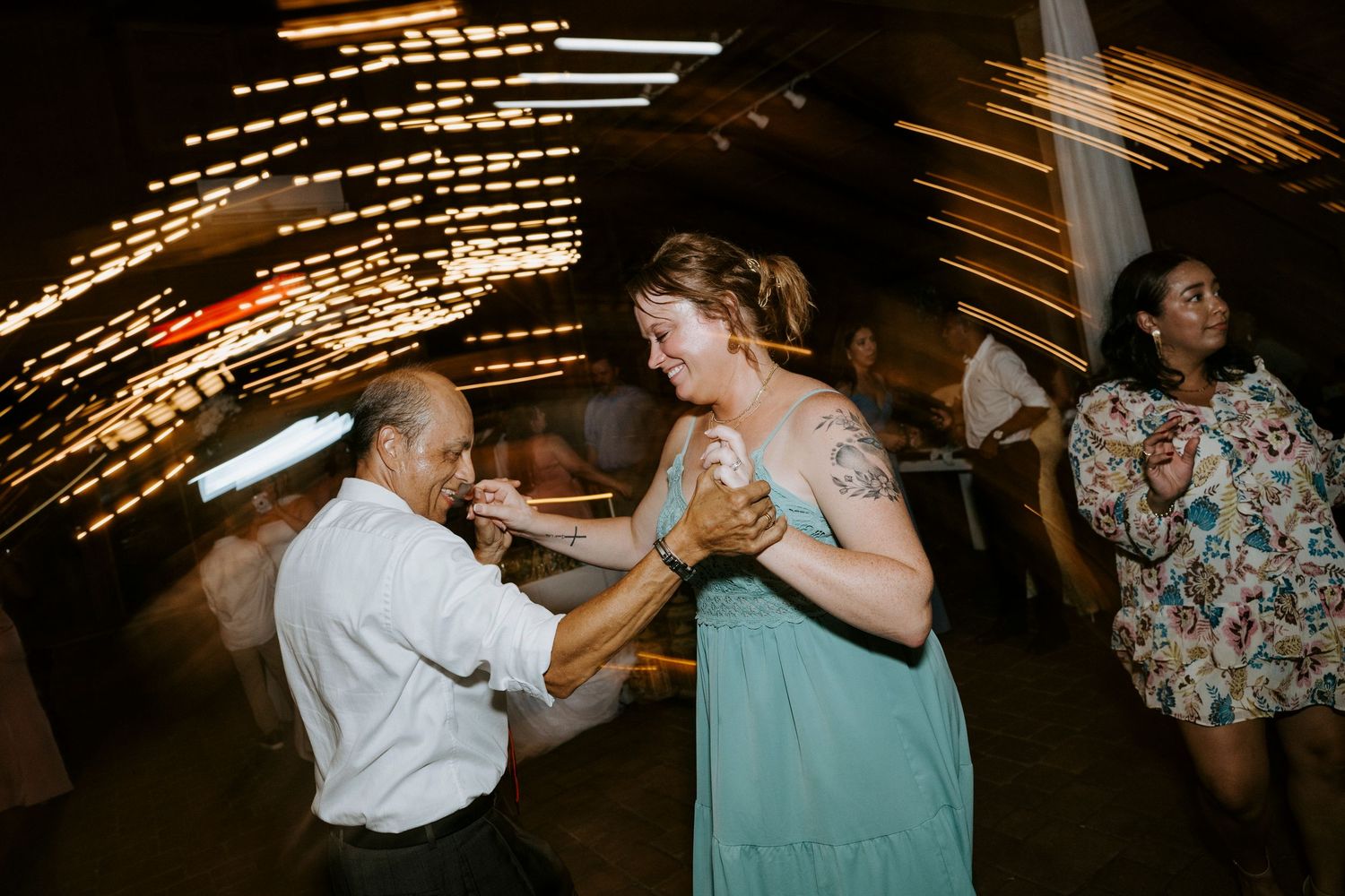 Sequence of dance moves captured at a wedding reception showing partners spinning and twirling on the dance floor.