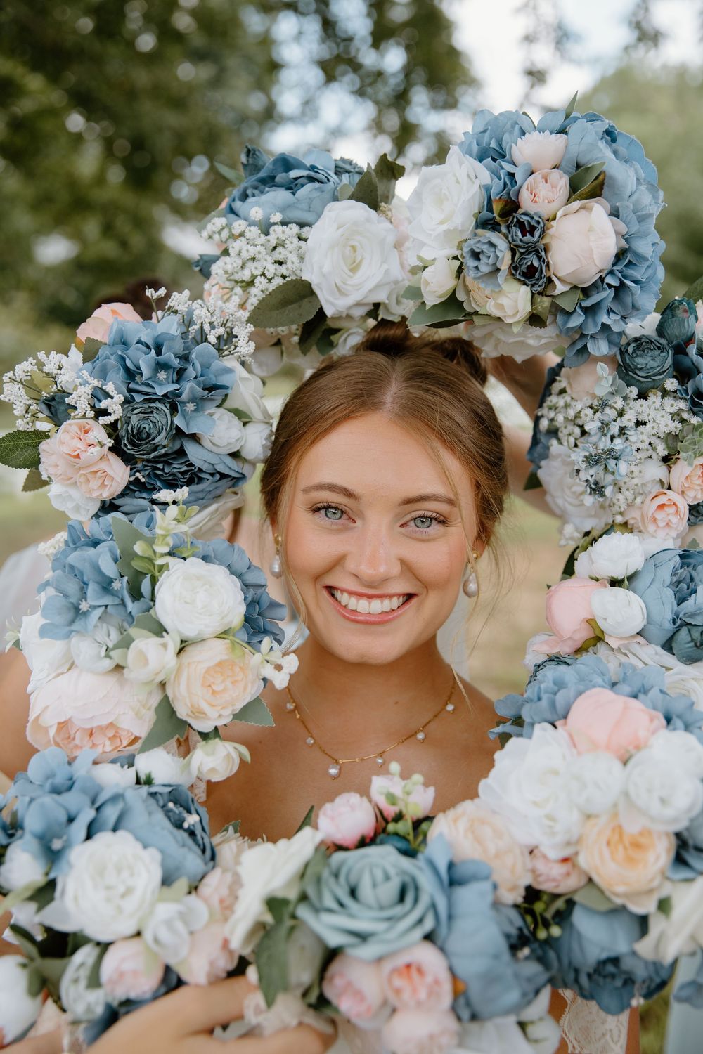 A beautiful floral arrangement featuring blue and pink roses with white baby's breath.