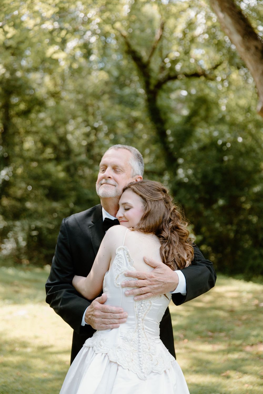 Tender moment shared during an outdoor wedding celebration.