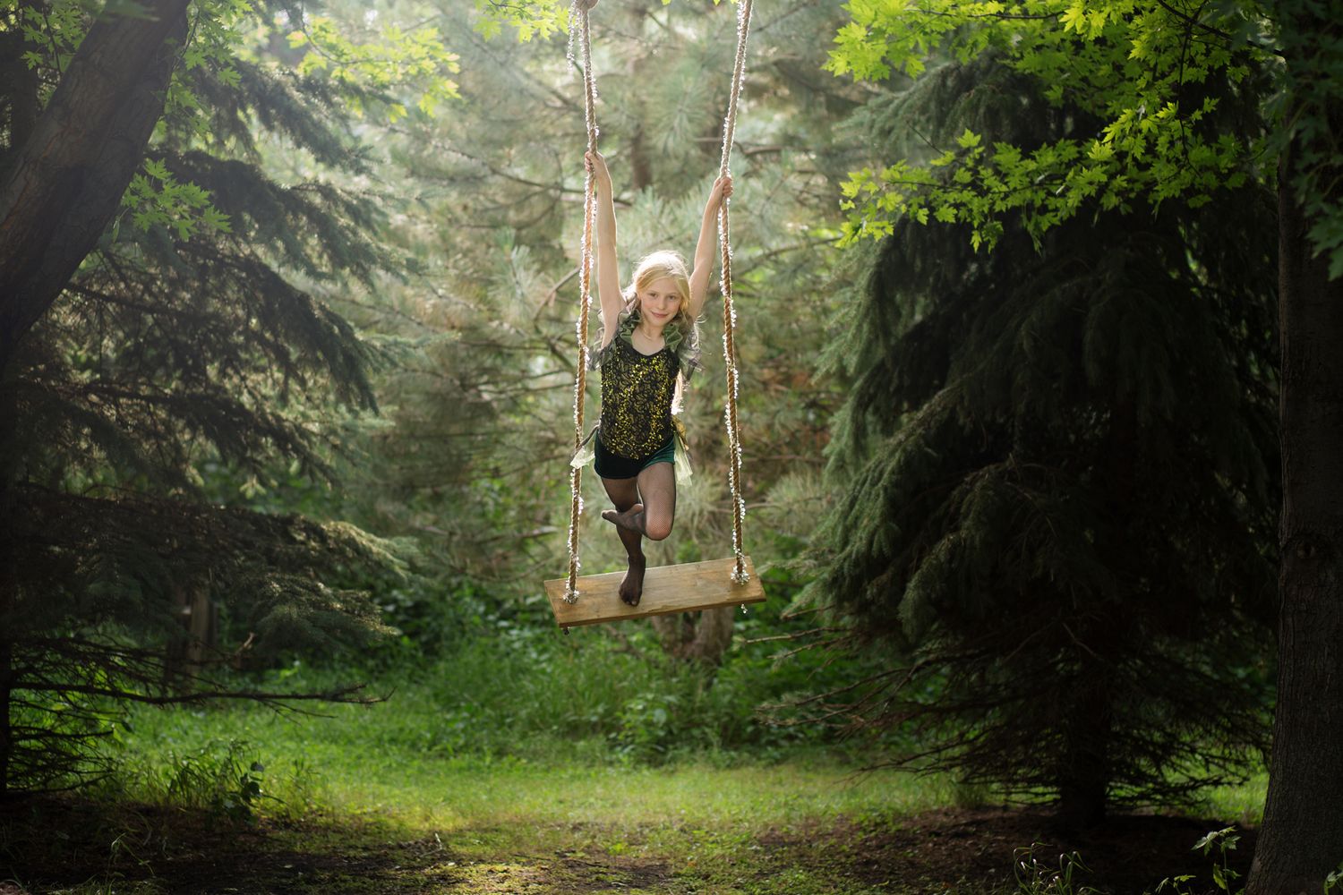 Creative photo shoot near Sioux Falls South Dakota featuring a child aerial artist on a swing made by the photographer.