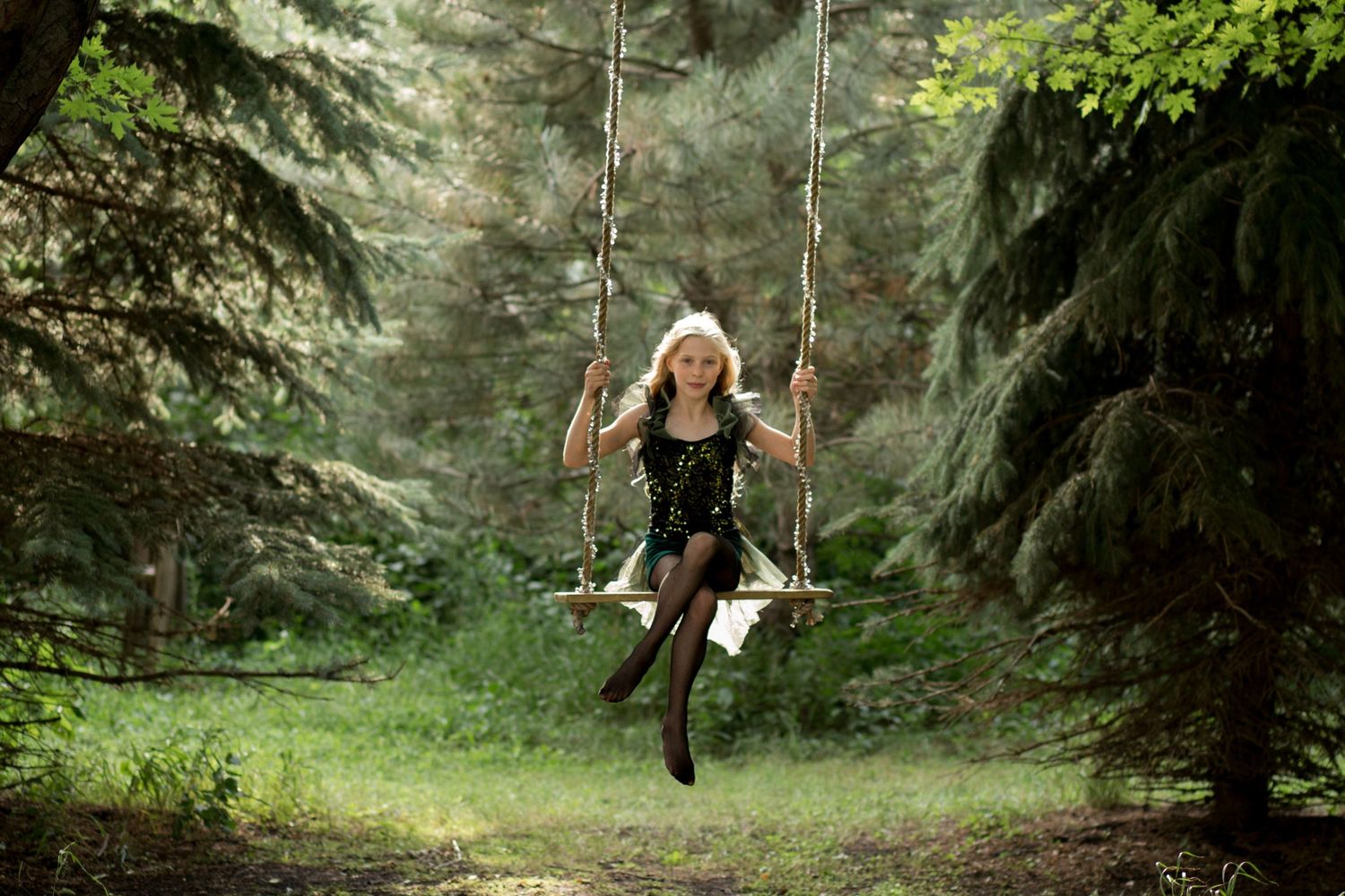 Creative photo shoot near Sioux Falls South Dakota featuring a child aerial artist on a swing made by the photographer.