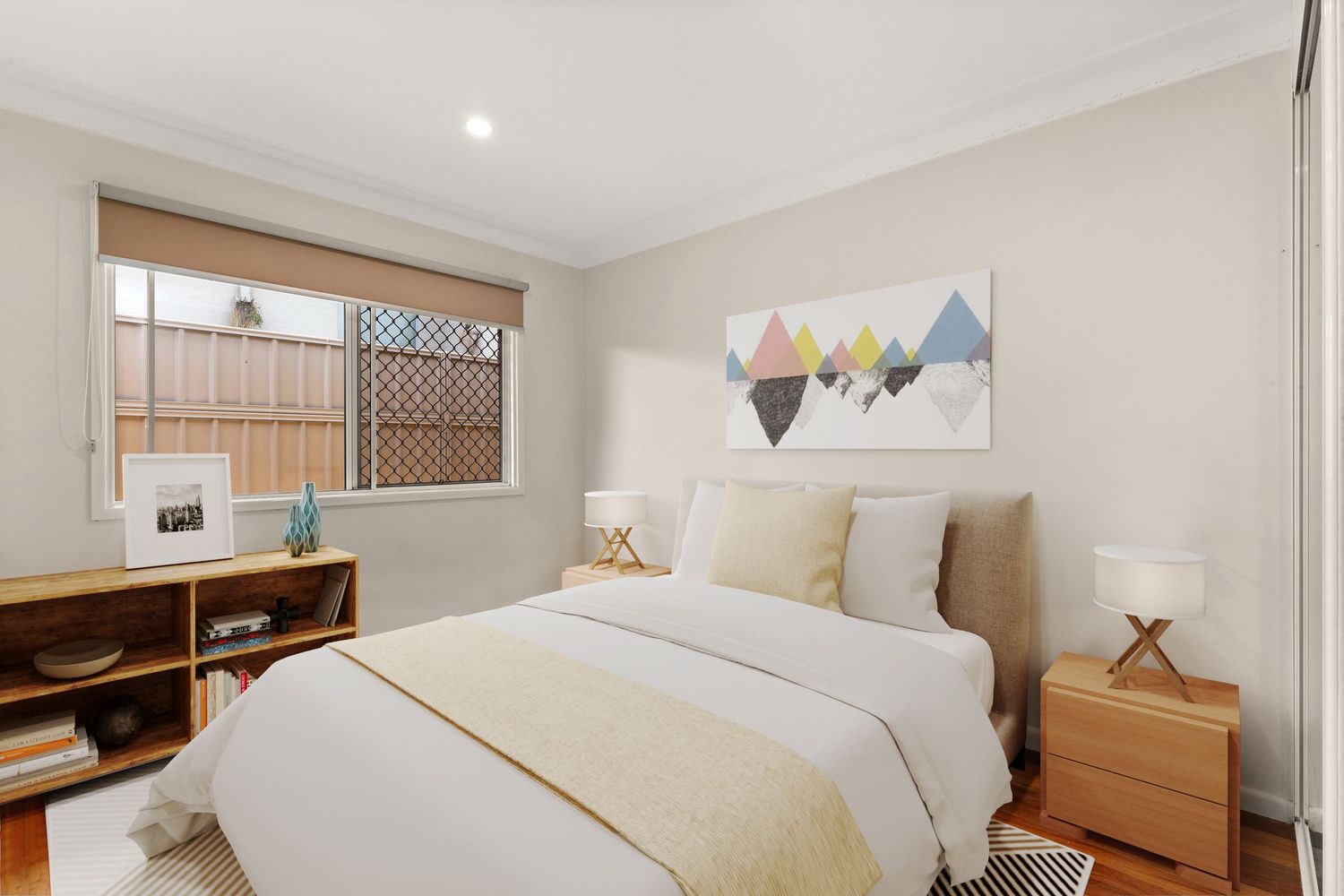 Bright bedroom with queen bed, neutral tones, timber bedside table, and colorful mountain artwork above the headboard.