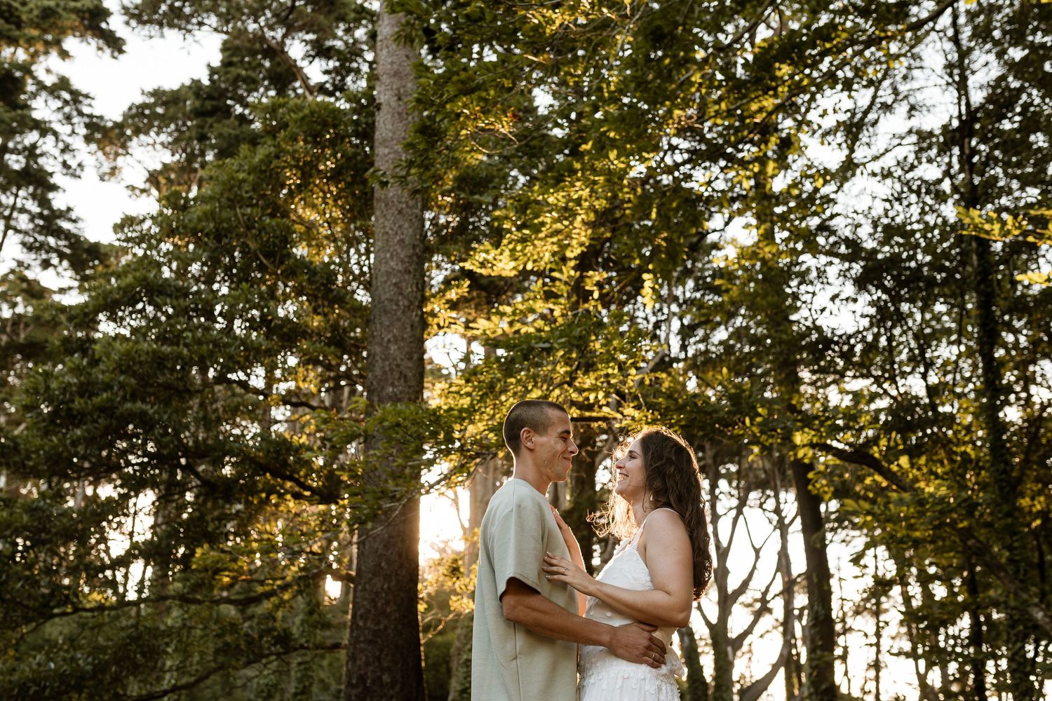 Romantic couple portrait in Sintra forest during golden hour pre-wedding session