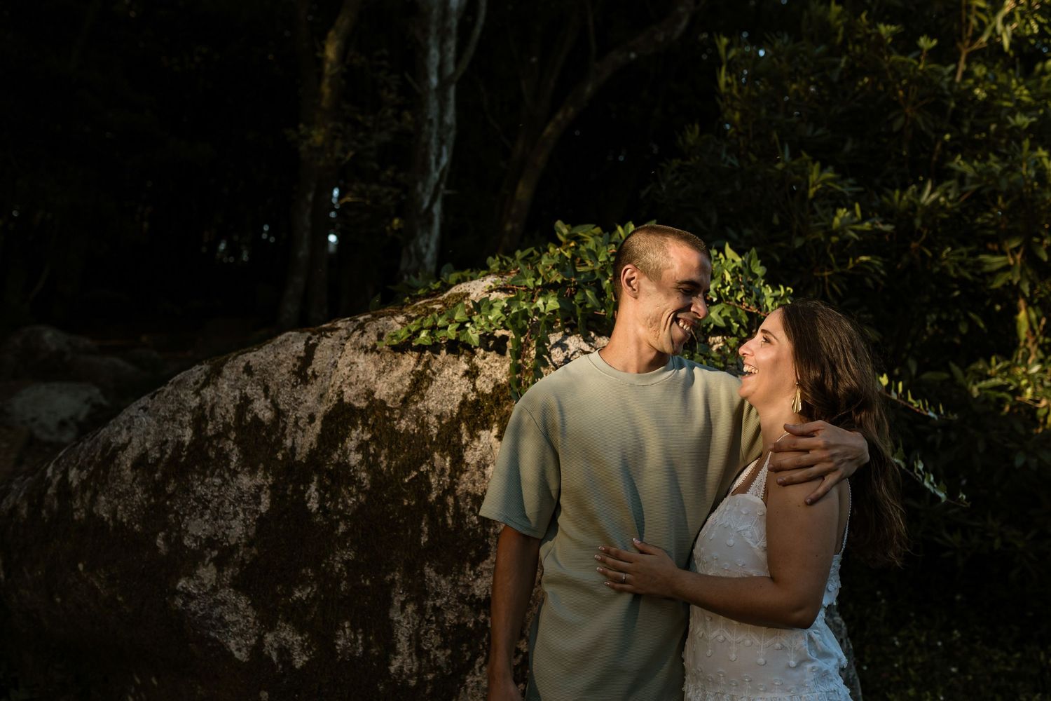 Couple embracing in dramatic forest light during Sintra pre-wedding photos