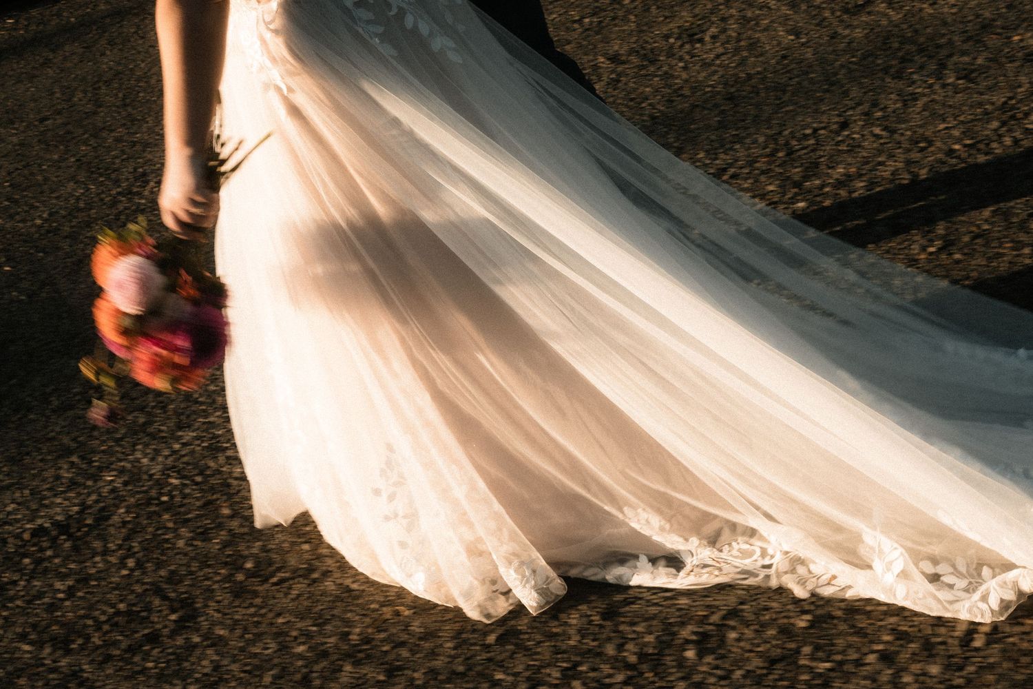 A flowing white wedding dress train trails elegantly across dark pavement in a series of artistic photos.