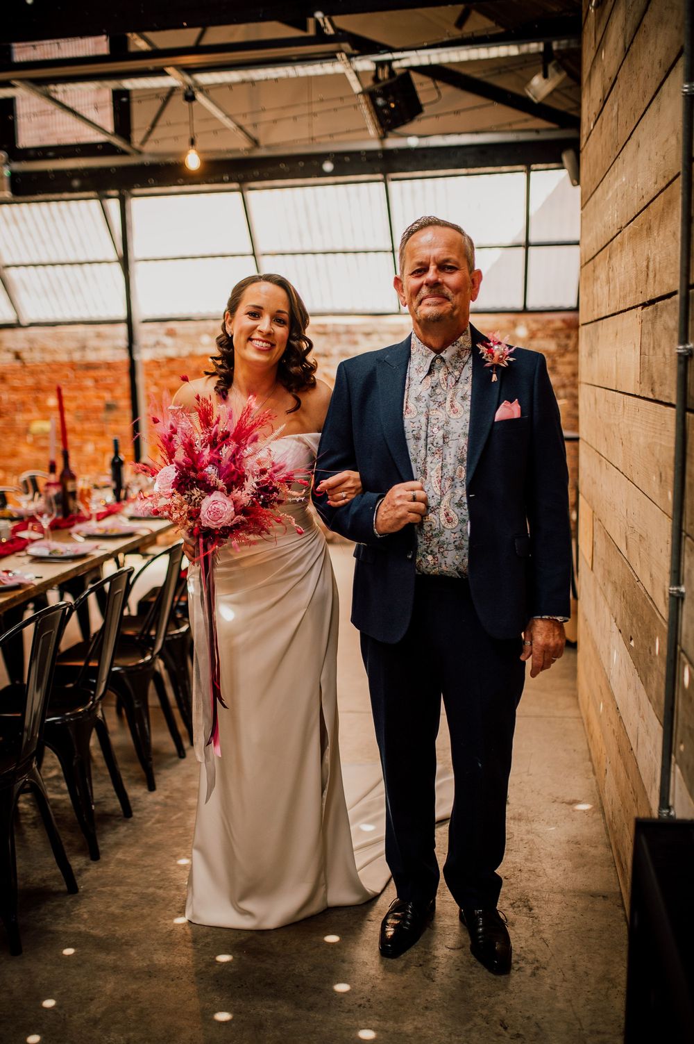 A series of wedding photos showing a couple walking down an indoor aisle with exposed brick walls and hanging lights.