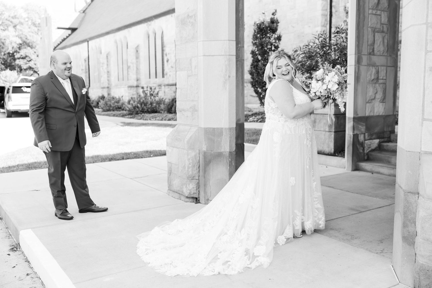 groom admiring his beautiful bride outside church after first look