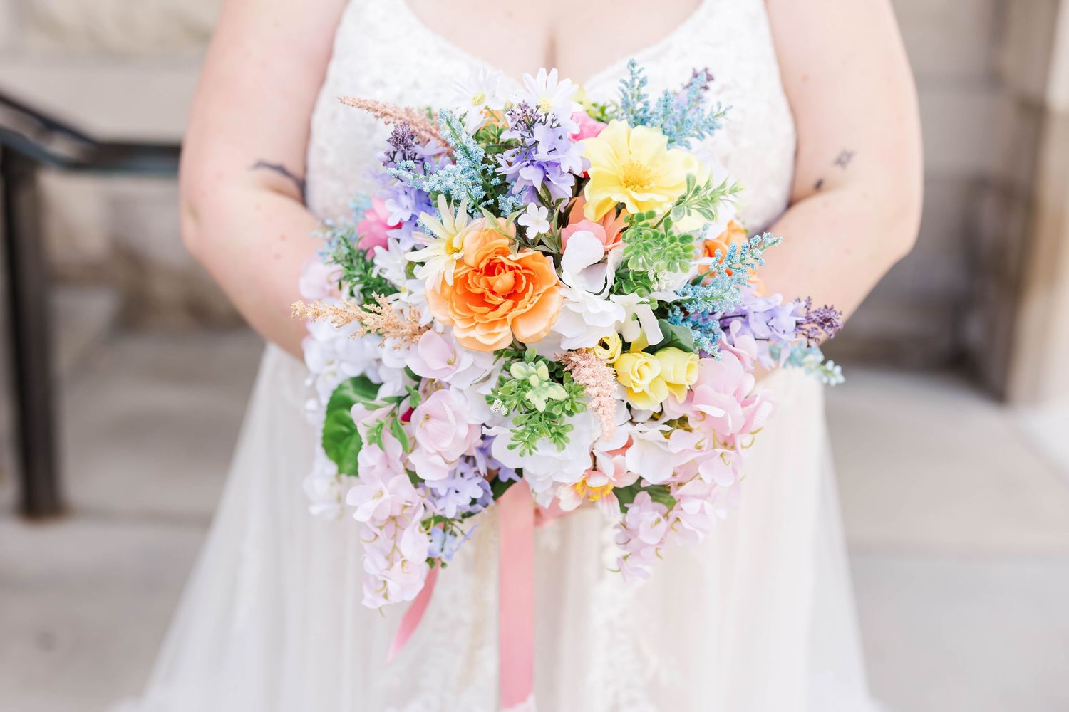 colorful detail shot of bridal bouquet and wedding dress springfield il