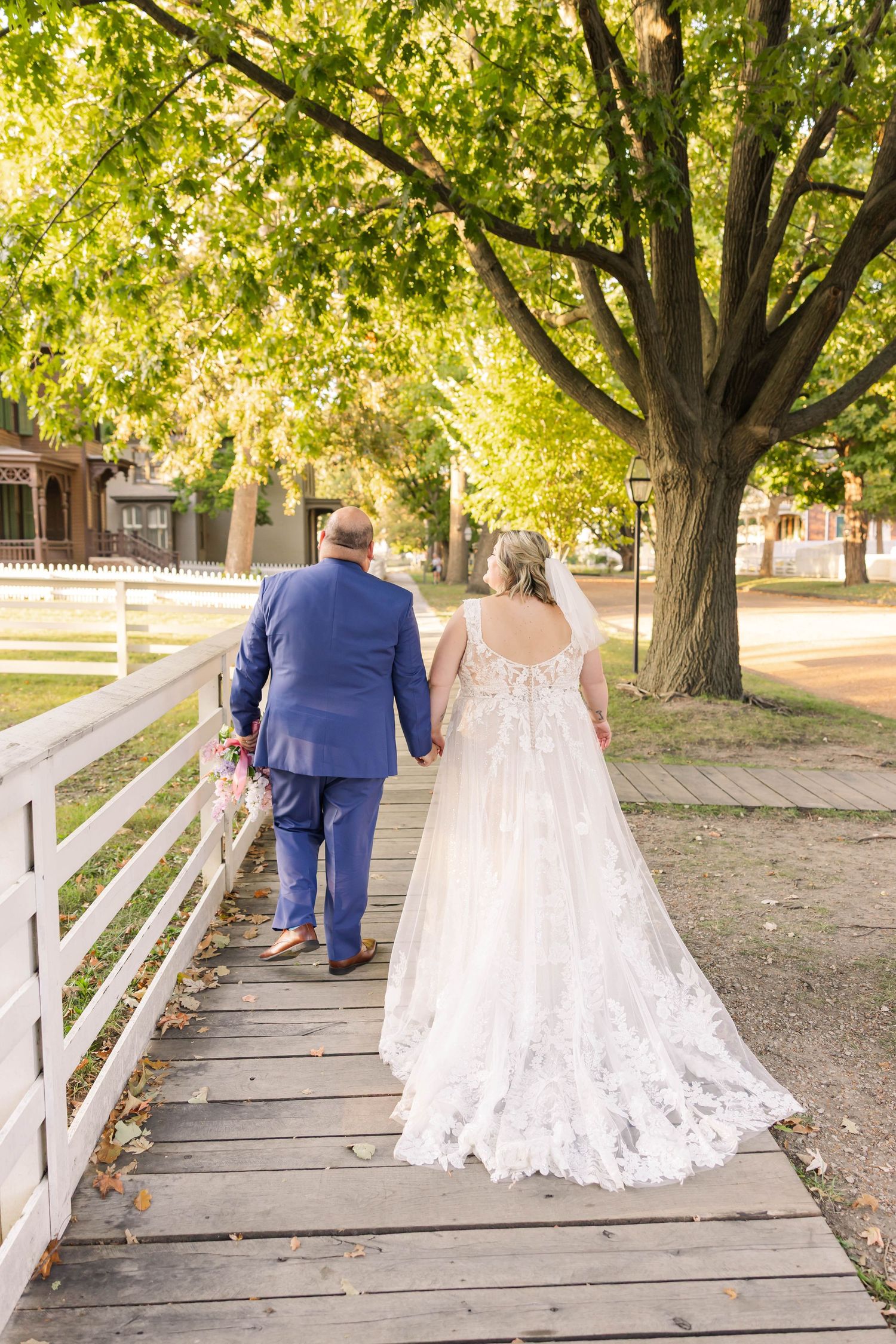 Newlyweds walking hand in hand during golden hour portraits at Lincoln Home National Historic Site