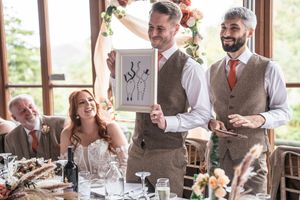 Wedding reception guests enjoying conversation and drinks at decorated tables.