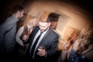 Candid reception photos show guests mingling and celebrating in warm ambient lighting.