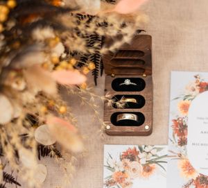 Wedding details featuring floral stationery and decorative elements in warm autumn tones.