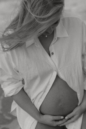 Black and white artistic photo series showing a white button-down shirt partially unbuttoned in different poses.