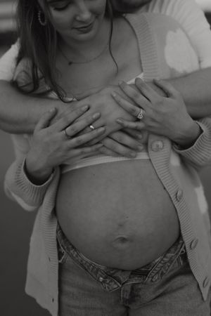 A black and white photo sequence showing someone unbuttoning their jeans to reveal their stomach.