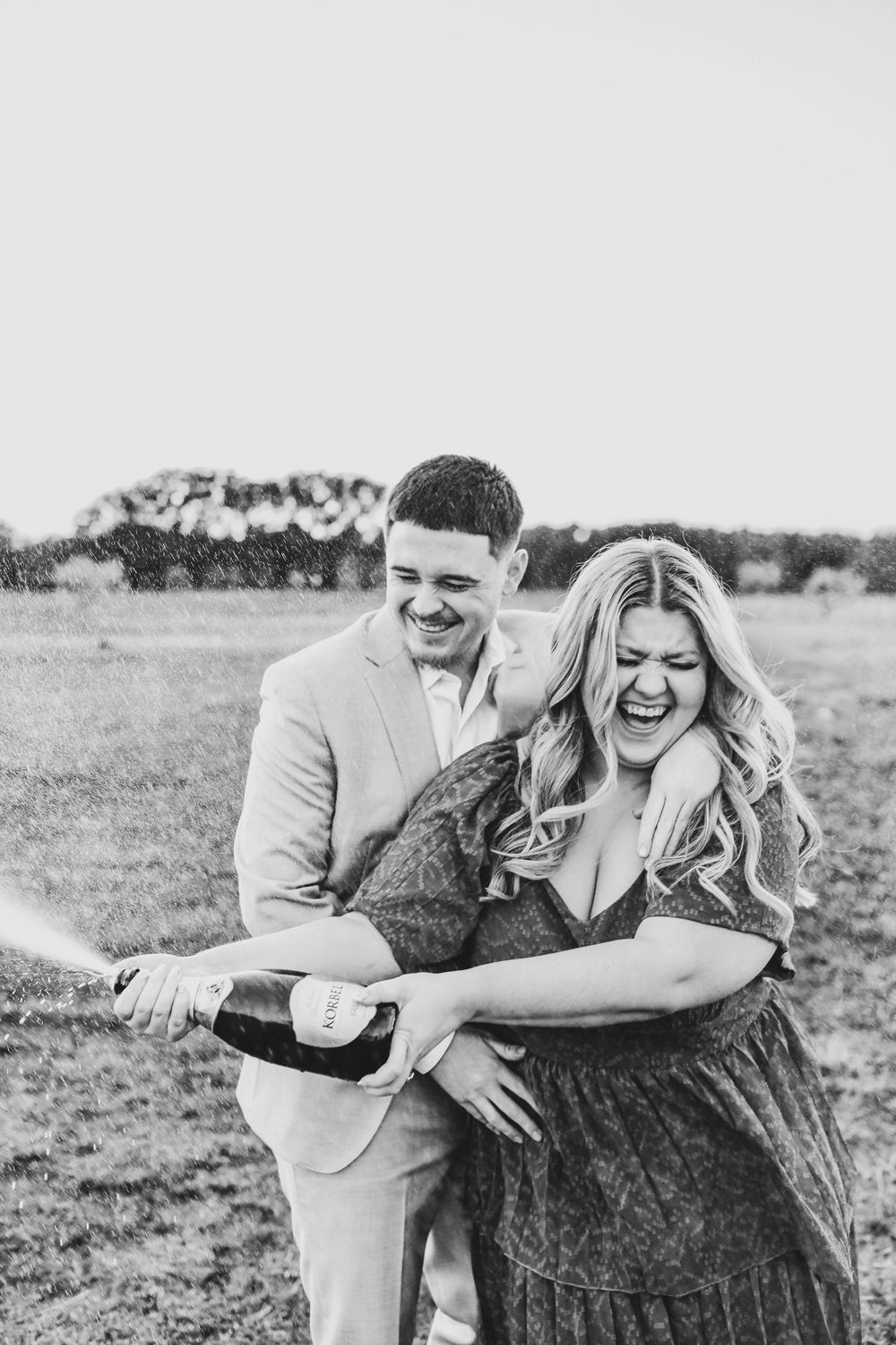Romantic field engagement photos near Grapevine Lake.
