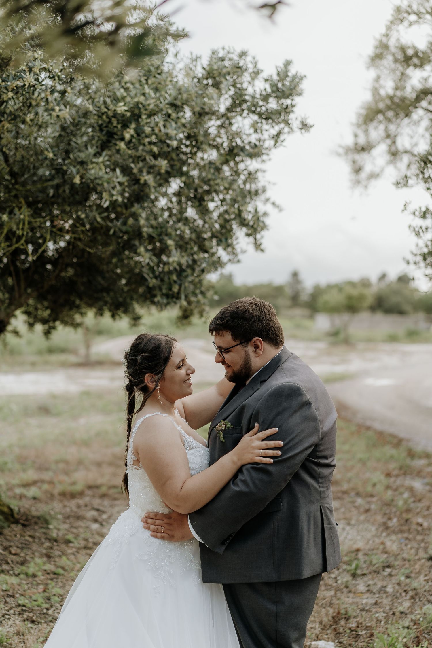 Romantic couple shares intimate moments during outdoor photo session in a natural setting.