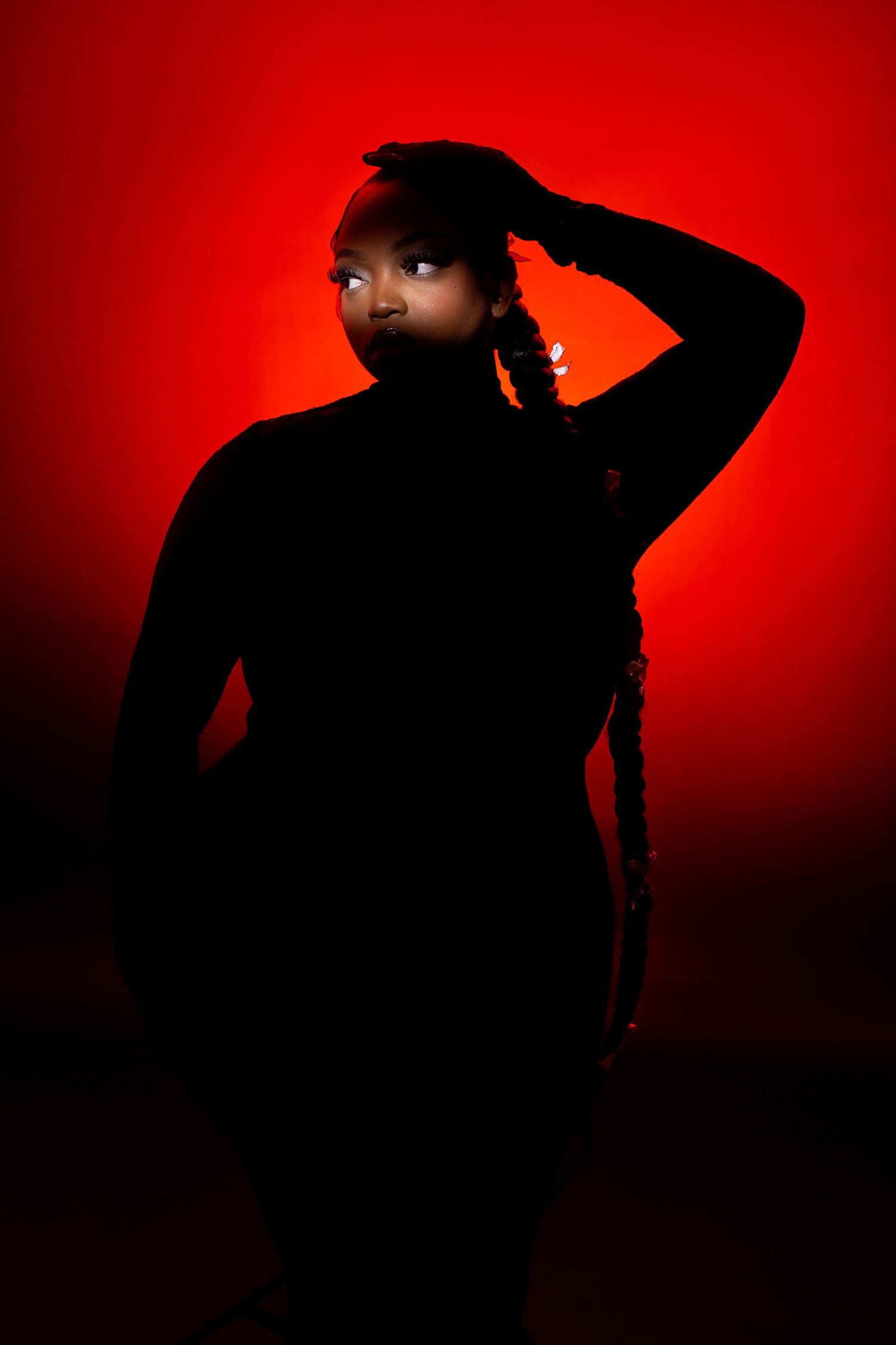 A portrait series showing dramatic angles and poses against a textured wall with blue lighting.