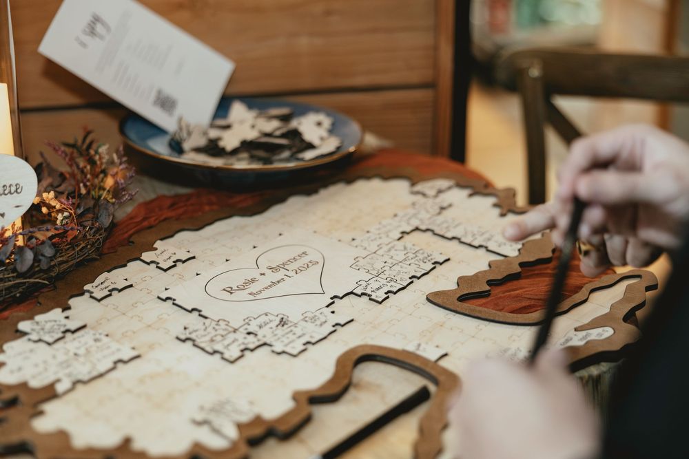 Delicate white lace doilies and crafting materials arranged on a rustic wooden table surface.