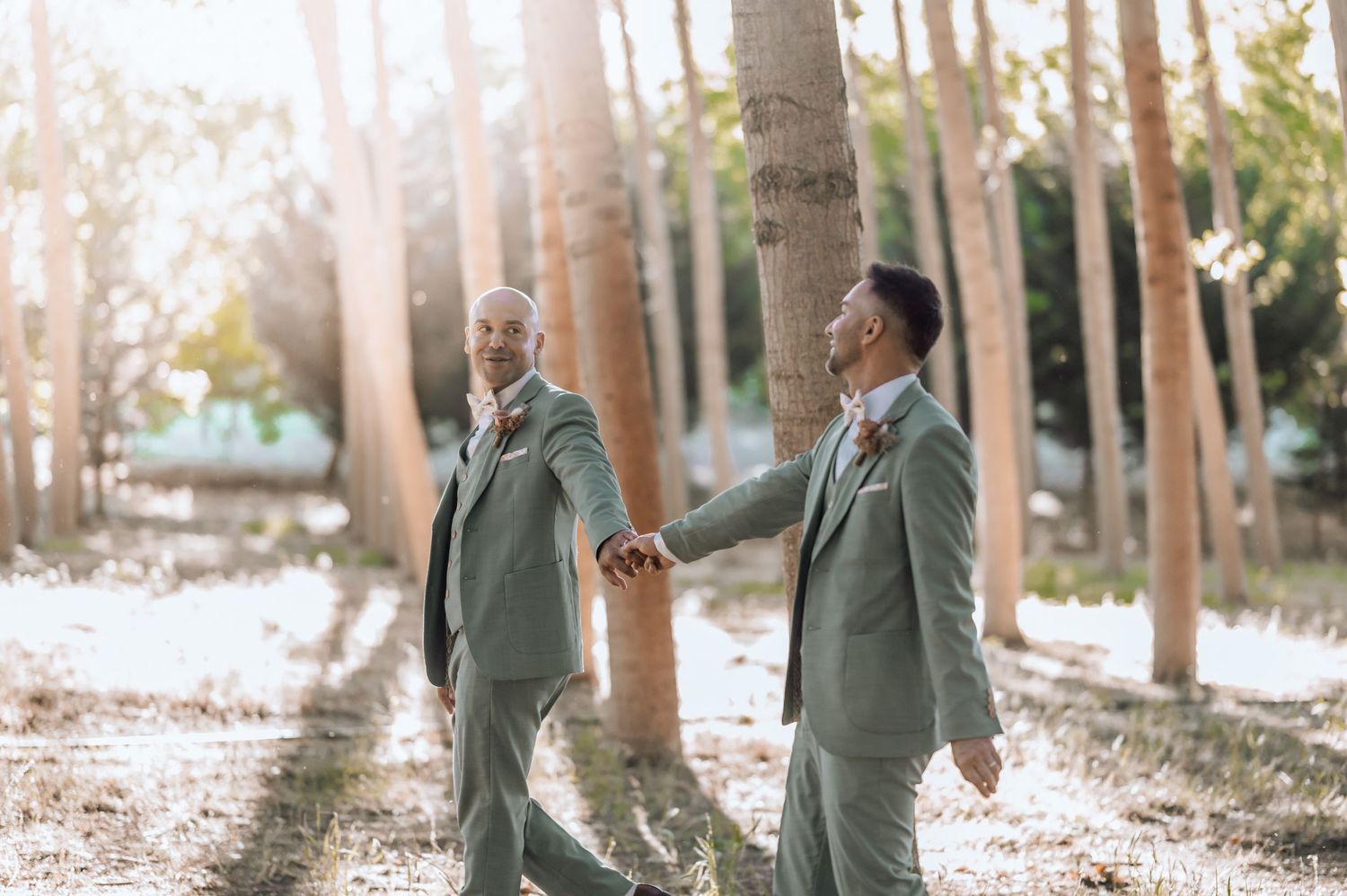 Close-up shot of hands exchanging wedding rings during an outdoor ceremony.