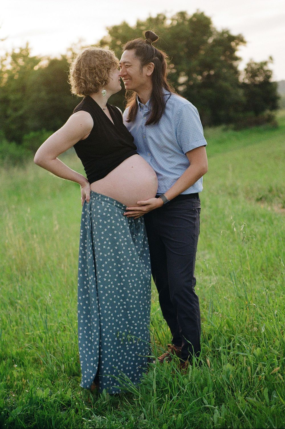 Film maternity photos from a Winter maternity session in Ventura County in green hills and golden light