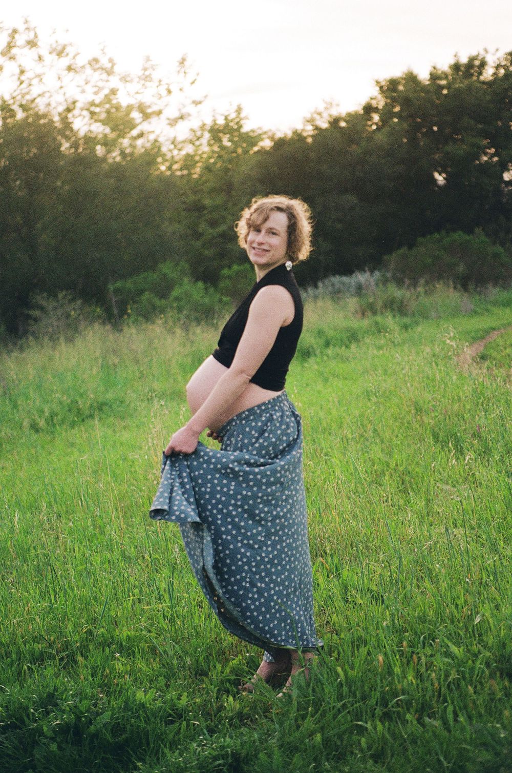 A pregnant woman dances for maternity photos on film in Thousand Oaks for a film maternity session