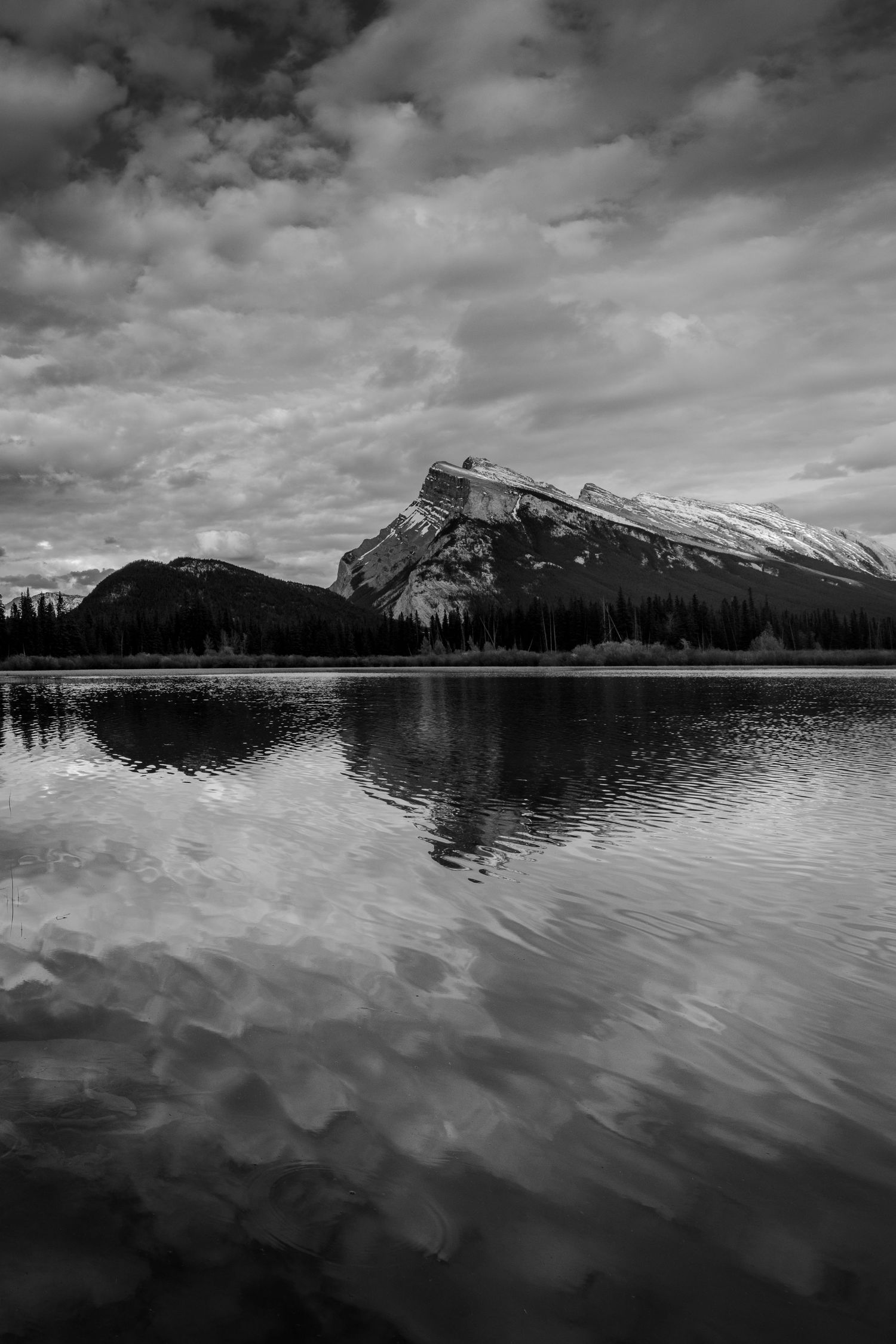Mount Rundle, Banff National Park, in black and white, monochrome to bring focus to the rippled reflection
