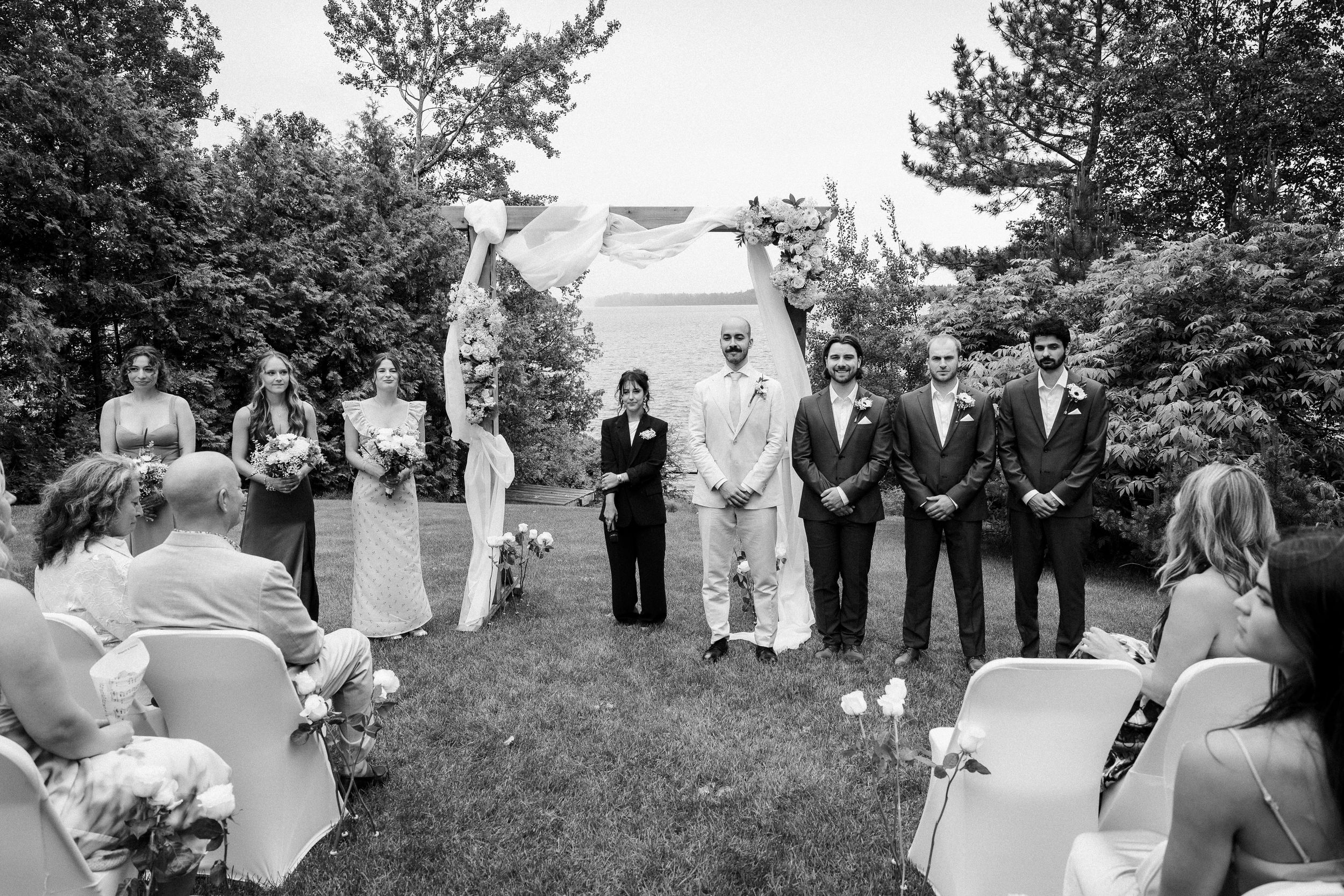 A series of black and white wedding ceremony photos showing outdoor celebrations with guests gathered in a garden setting.