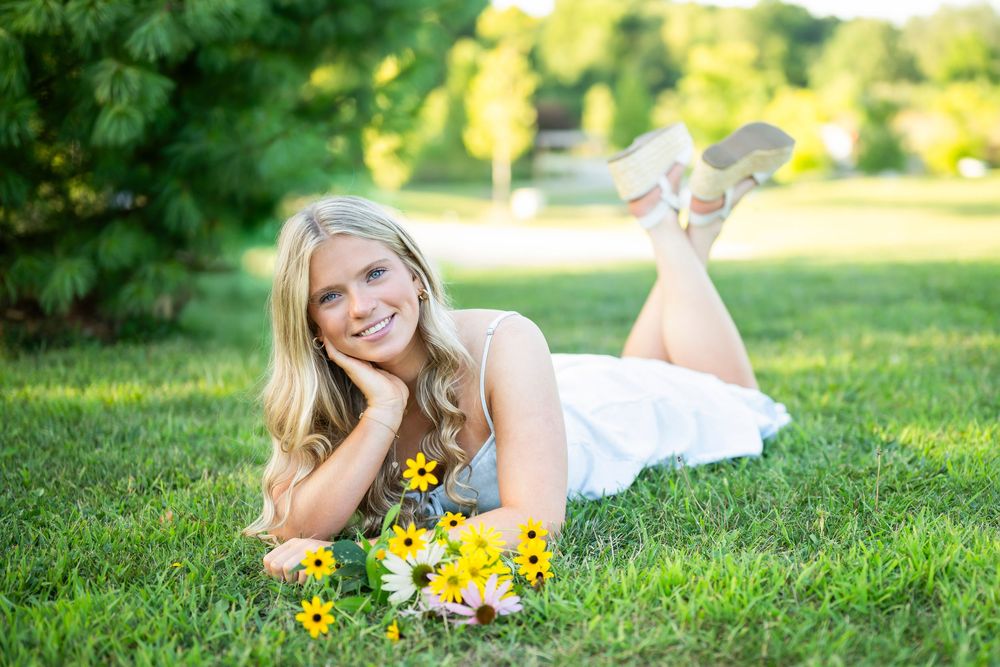 A series of outdoor portraits in a sunny park setting with yellow flowers and green grass creating a natural backdrop.