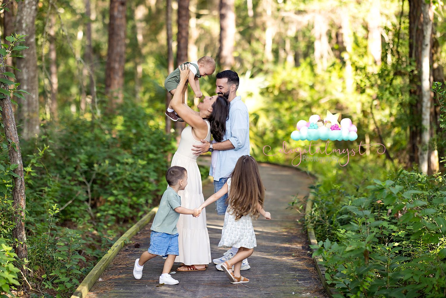 Family walking together on a scenic forest path surrounded by lush greenery on a sunny afternoon.