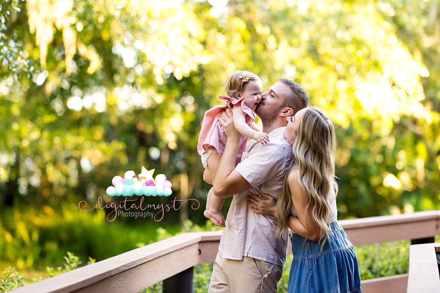 Two people share a tender moment in a sunlit garden setting wearing pink and blue outfits.