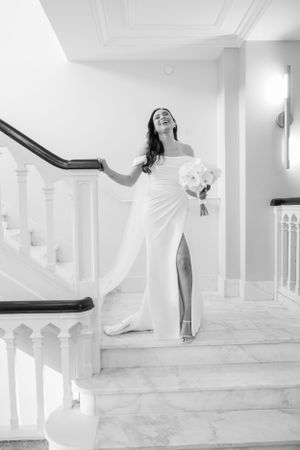 Playful bridal portraits on a white staircase showing movement and joy.