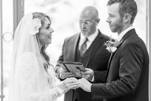 Wedding couple and guests share joyful moments during a celebration in an elegant indoor venue.