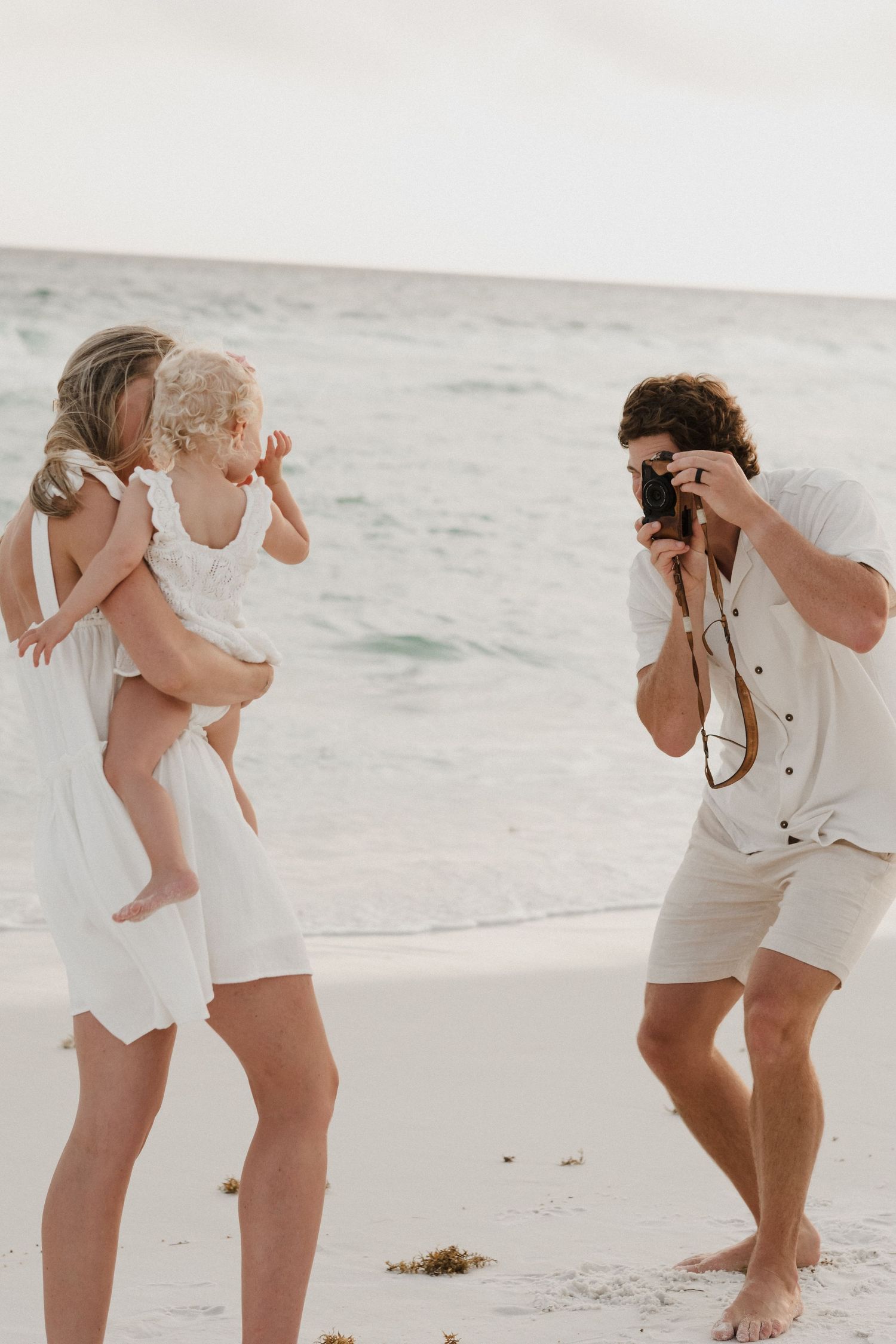 Two people in floral outfits enjoying a day at the beach.