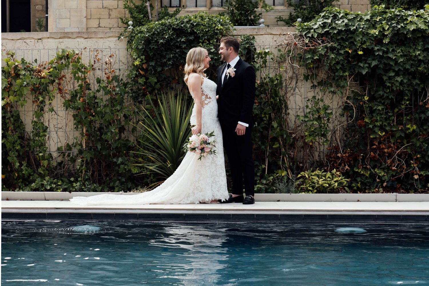 Cotswolds Wedding Photographer Zara Davis Photography Gloucestershire Ellenborough Park couple kissing by the pool