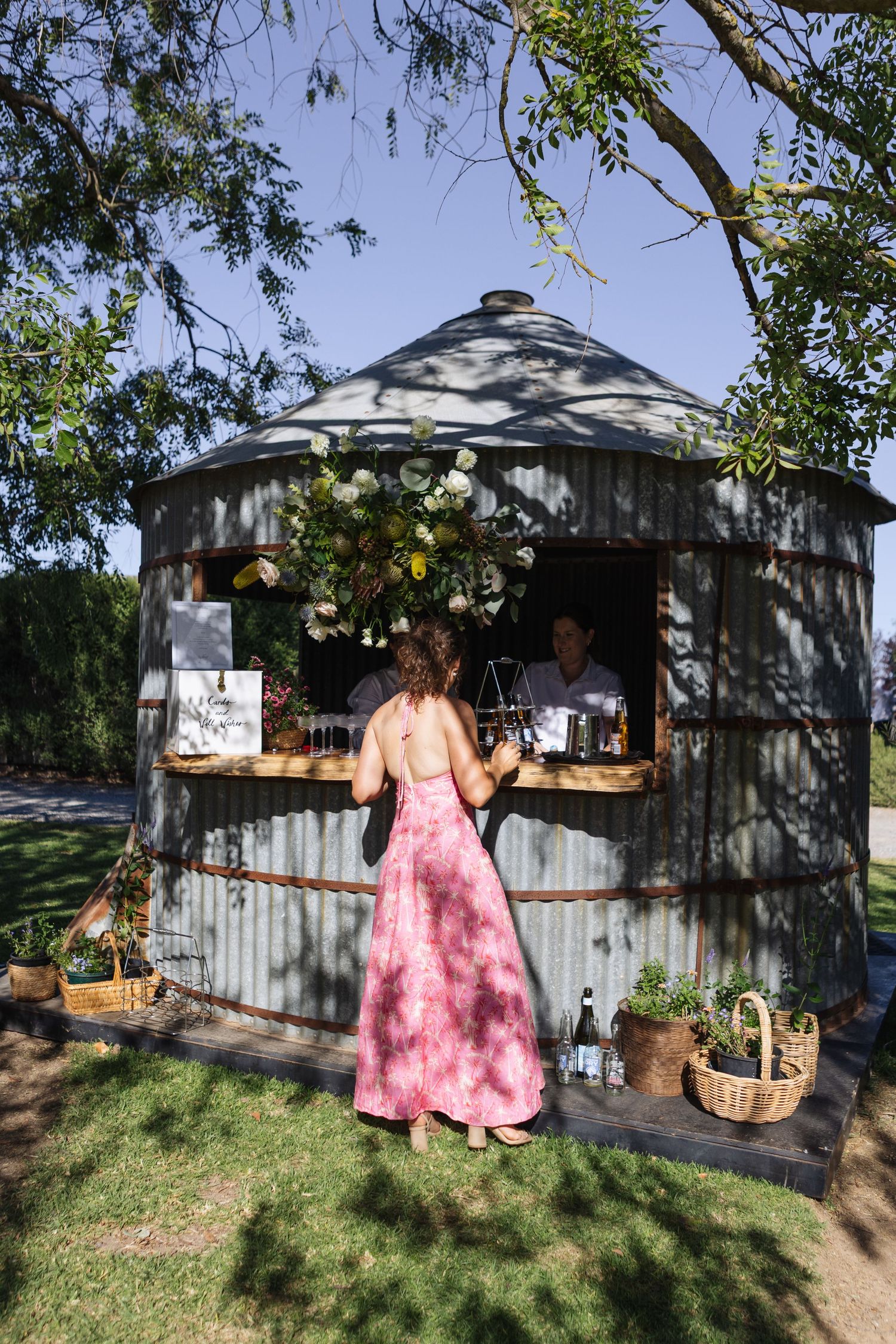 lady ordering drink from silo bar at country wedding