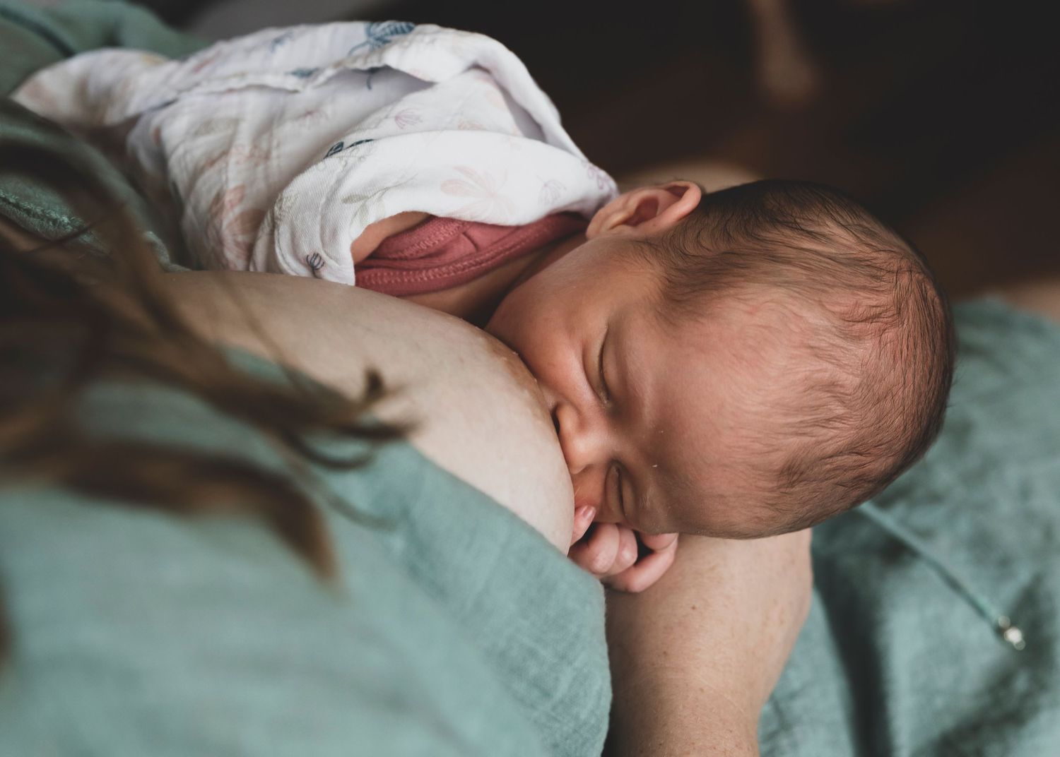 In‑home newborn session in Perth showing relaxed, unposed moments on the family bed.