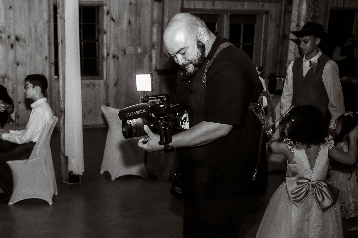 Black and white photos showing a wedding celebration with dancing and candid moments at an indoor venue.