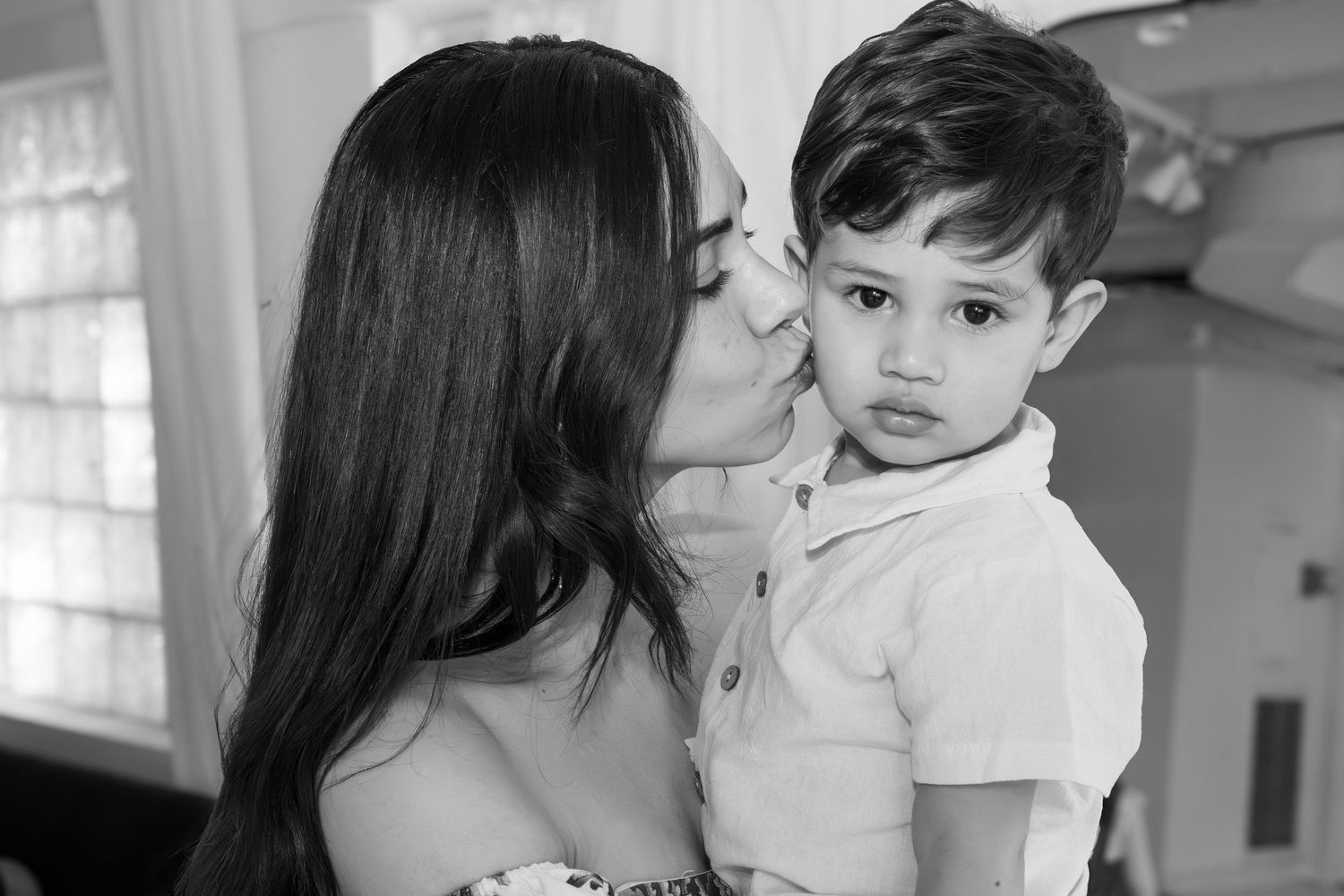 A black and white photo collage shows tender family moments between parent and child in various poses.