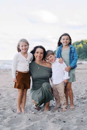 A series of candid beach photos showing a family posing together on sandy shores at sunset.