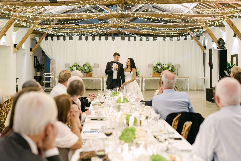 Bride and groom speaking to guests during wedding dinner reception at Quinta Nova do Hespanhol