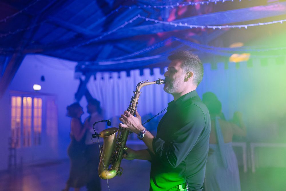 Live saxophone performance on dance floor creating vibrant atmosphere at Lisbon wedding reception