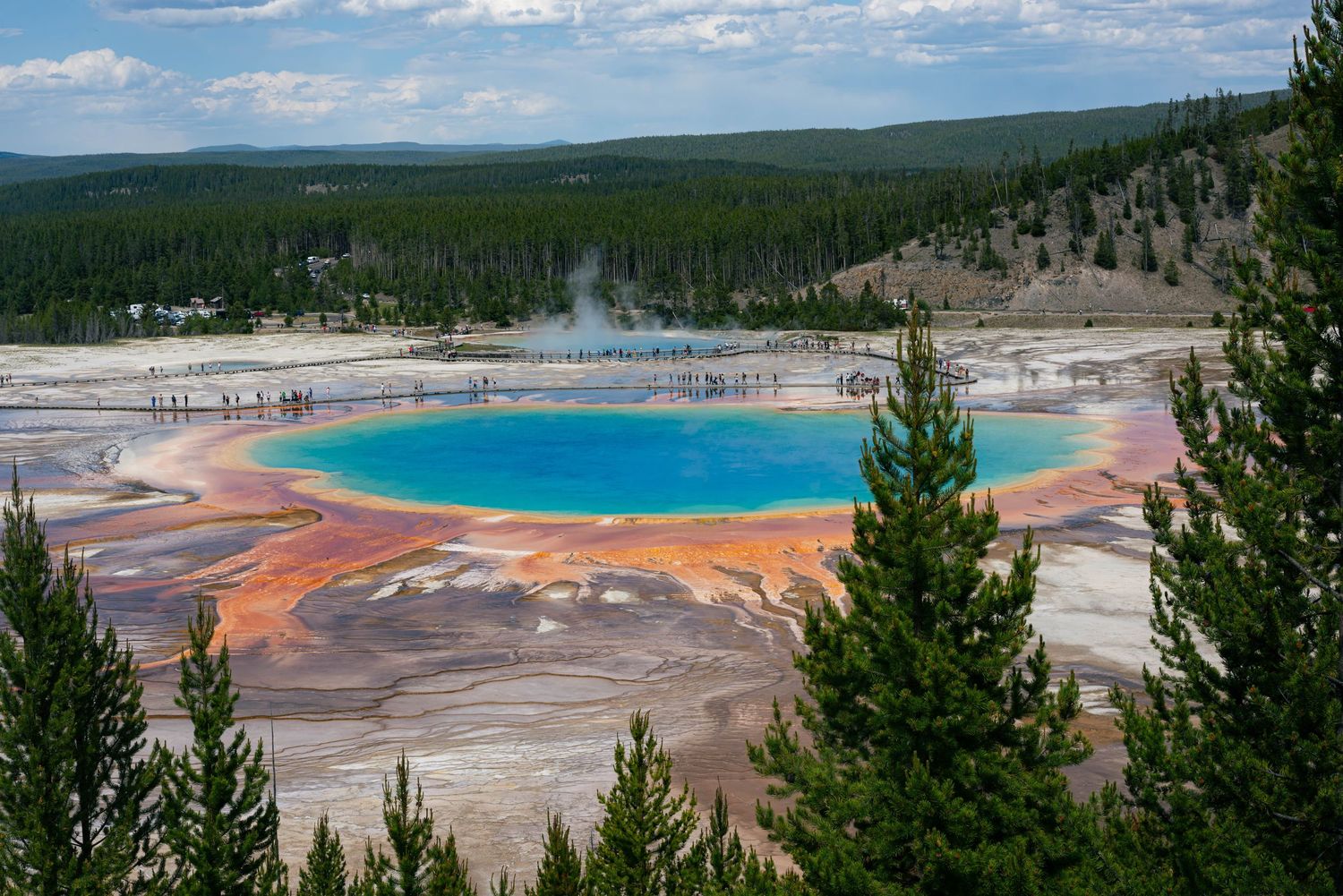 Aerial view of Grand Prismatic Spring in Yellowstone National Park with its vibrant rainbow colors and steaming hot water.