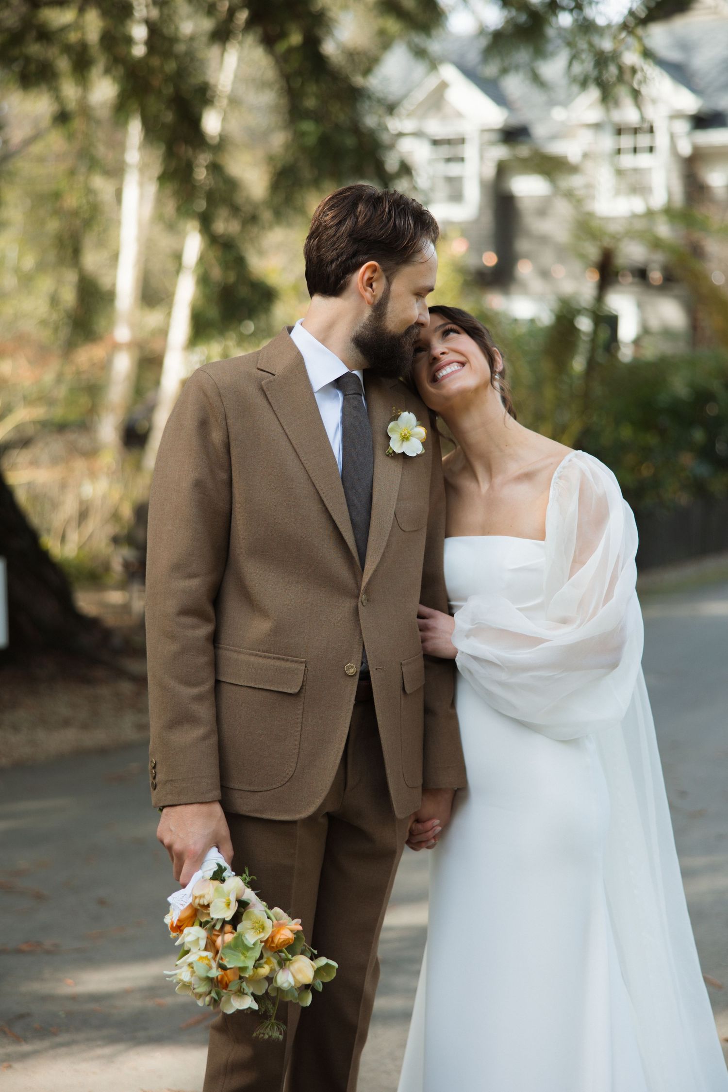 Bride and groom portraits with a groom in a brown vintage suit and bride in a modern white gown with a sheer cape
