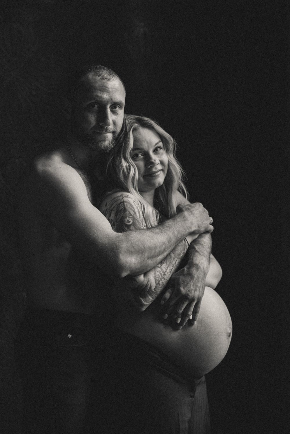 Intimate black and white maternity photography showing tender moments.