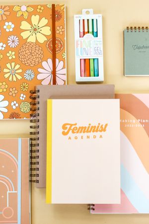 array of notebooks, journals, and pens.