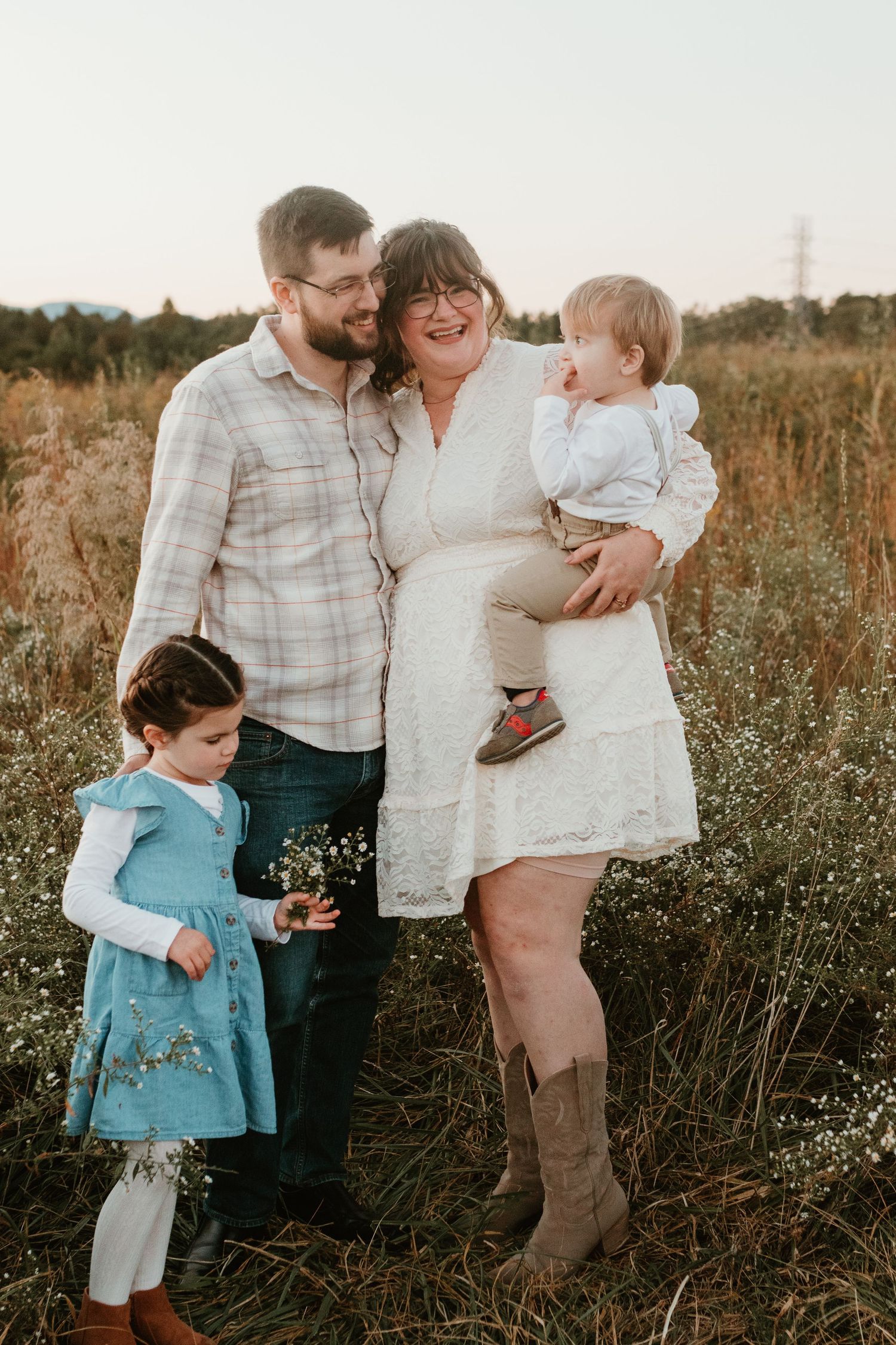 Spartanburg SC Family photographer taking photos in field while boy runs around pretending to be an airplane