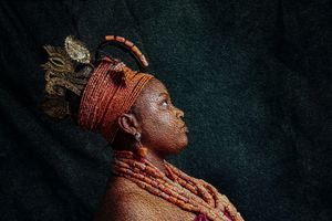 Photography Oil painting Side profile portrait showcasing intricate African headpiece and coral beaded jewelry of a Benin bride