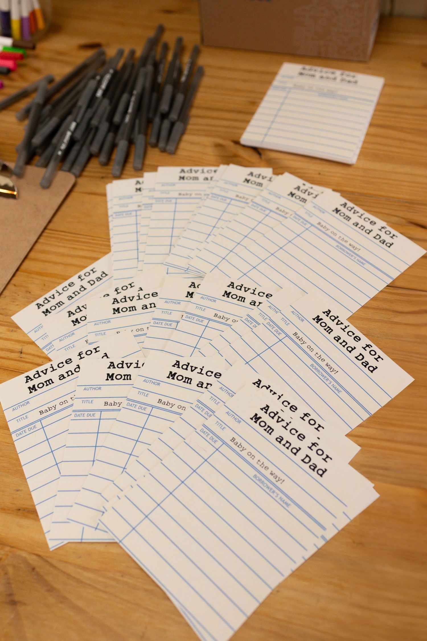 Collection of handwritten advice cards arranged in a fan pattern with pens.