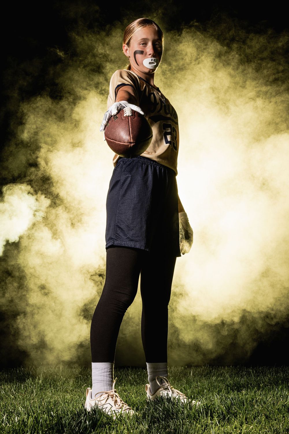 A sequence of basketball dribbling action shots against a dark smoky background on grass.