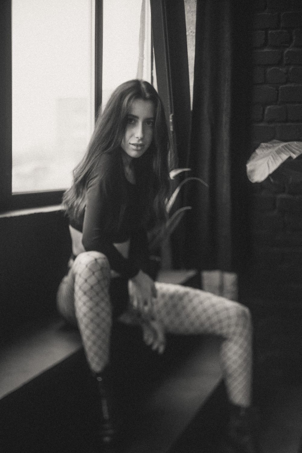 Moody black and white portrait series in an industrial setting.